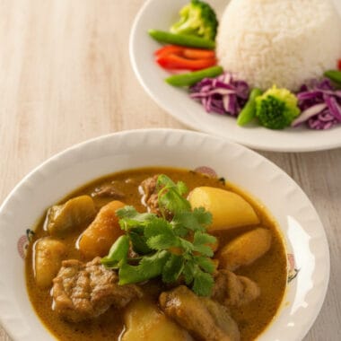 Bowl of Khmer beef curry with mango and coconut milk