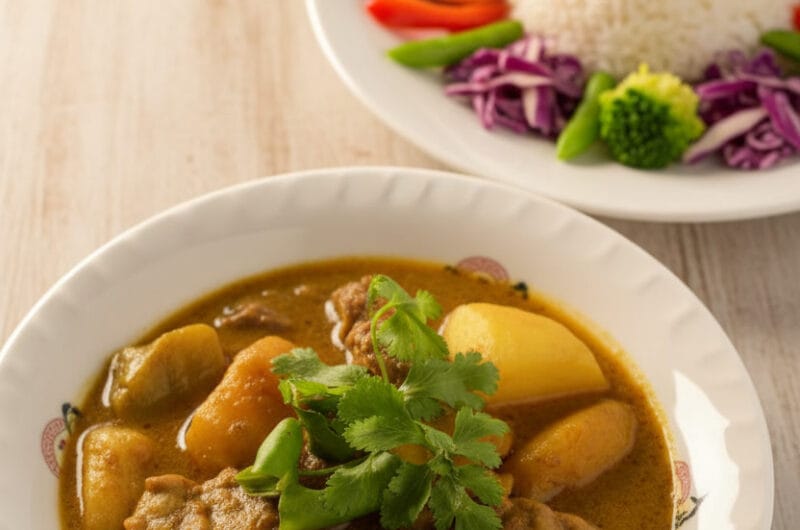 Bowl of Khmer beef curry with mango and coconut milk