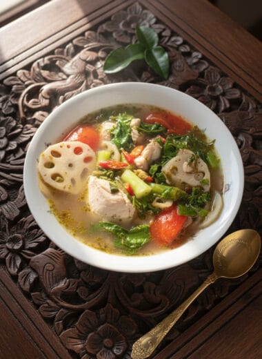 Bowl of hot sour chicken soup with lotus shoots