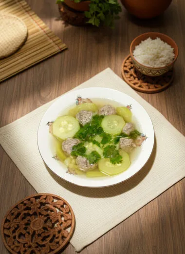 Khmer zucchini soup with grounded pork in a ceramic bowl