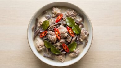 Bowl of Cambodian banana flower soup with chicken, coconut milk, and lemongrass.