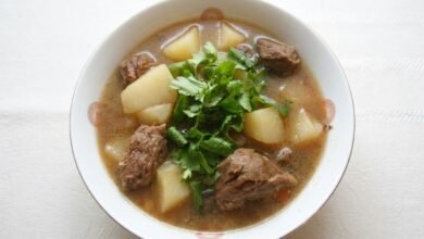 Overhead view of Beef and Potato Soup with tender beef, potato chunks, and fresh cilantro in a bowl.