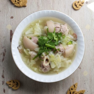 Centered bowl of pork hocks and cabbage soup in Khmer kitchen