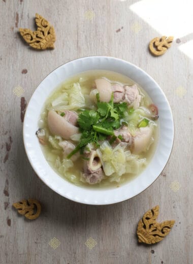 Centered bowl of pork hocks and cabbage soup in Khmer kitchen