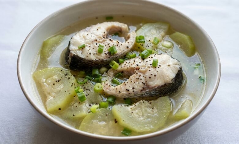 A bowl of Cambodian opo squash and fish soup with green onion and black pepper.