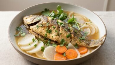 Whole stuffed boneless fish in a light broth with daikon, carrot, and cilantro.