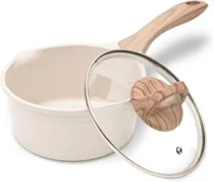 Small stainless steel cooking pot with lid on white background
