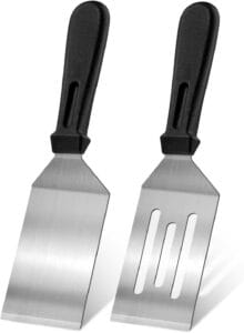 Stainless steel kitchen spatula used for flipping and stirring food during cooking