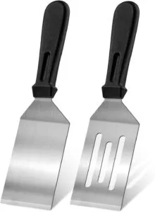 Stainless steel kitchen spatula used for flipping and stirring food during cooking