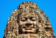 A carved stone face on a tower at Bayon Temple in Angkor Thom, Cambodia.