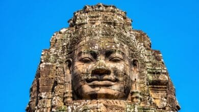 A carved stone face on a tower at Bayon Temple in Angkor Thom, Cambodia.