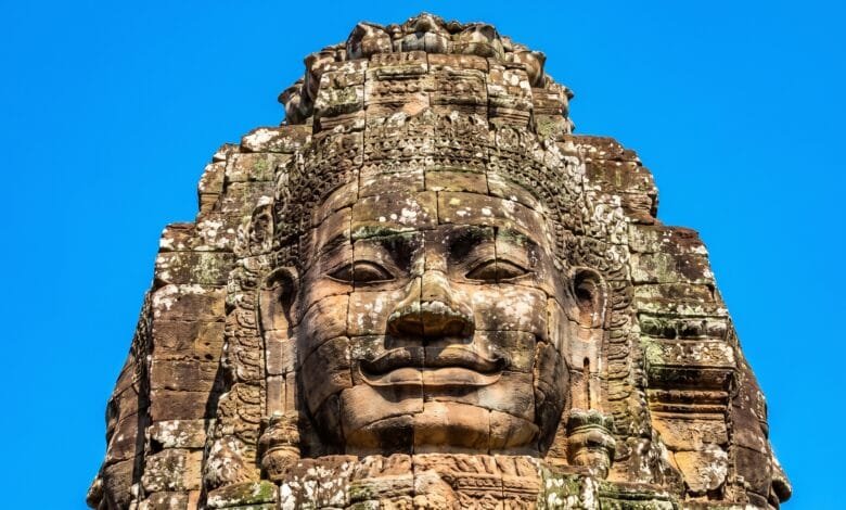 A carved stone face on a tower at Bayon Temple in Angkor Thom, Cambodia.