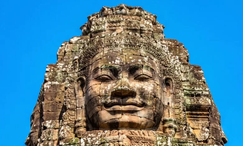 A carved stone face on a tower at Bayon Temple in Angkor Thom, Cambodia.