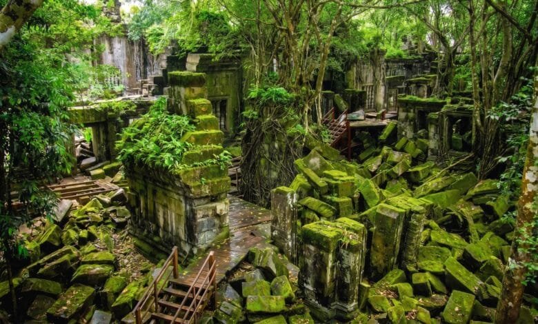 Collapsed sandstone blocks and tree roots at the unrestored Beng Mealea temple in Cambodia