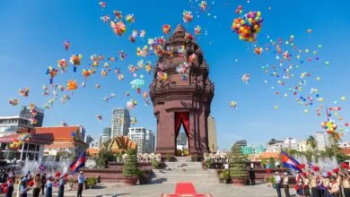 Crowds gather around the Independence Monument in Phnom Penh during the Cambodia Independence Day ceremony on November 9, with the Cambodian flag flying overhead.