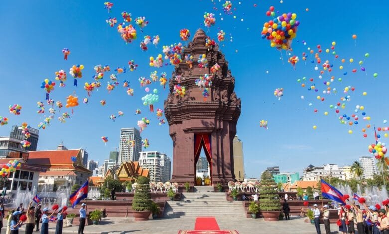 Crowds gather around the Independence Monument in Phnom Penh during the Cambodia Independence Day ceremony on November 9, with the Cambodian flag flying overhead.