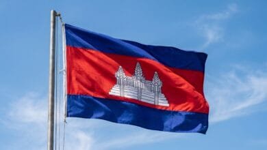 Cambodia's national flag with blue and red horizontal stripes and a white Angkor Wat temple in the center