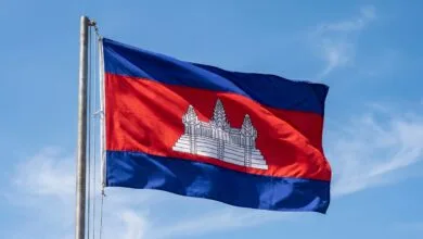 Cambodia's national flag with blue and red horizontal stripes and a white Angkor Wat temple in the center