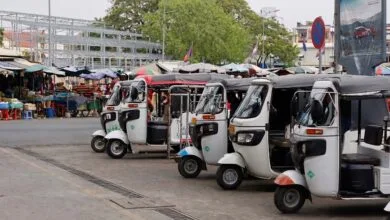 tuk-tuk parking near a busy market in Phnom Penh, Cambodia