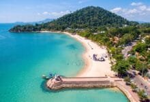 Calm shallow water along Kep Beach, a crescent-shaped public beach in Kep, Cambodia