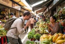 A foreign traveler greets a Cambodian market vendor with hands pressed together in the traditional sampeah gesture