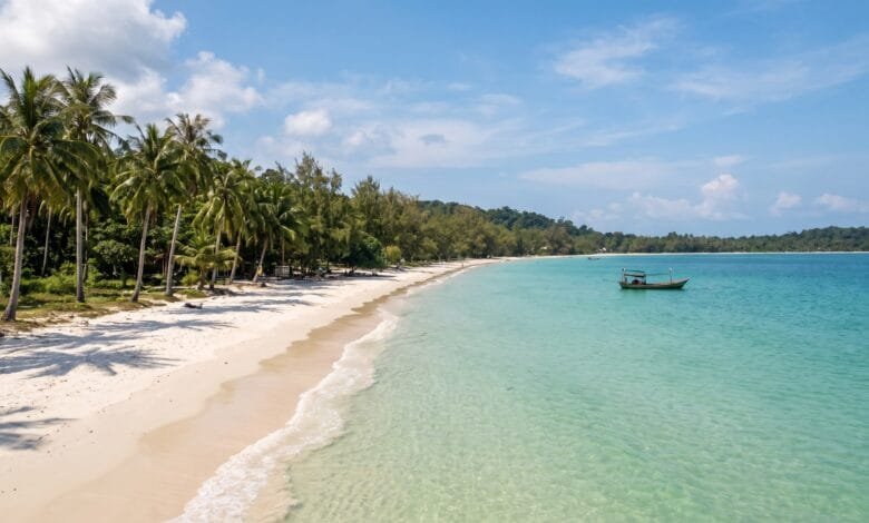 White sand beach with palm trees and clear tropical water on Koh Rong island in Cambodia