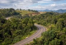 Rolling green hills and forested highland landscape near Sen Monorom in Mondulkiri province, Cambodia