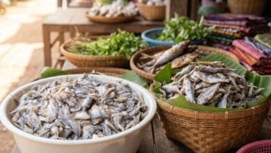Cambodian prahok fermented fish paste in a bucket with fresh lemongrass and chilies