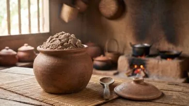 Prahok fermented fish paste in a traditional Cambodian clay jar on a woven bamboo mat