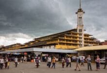 Psar Nat Market's yellow Art Deco building with clock tower in Battambang, Cambodia