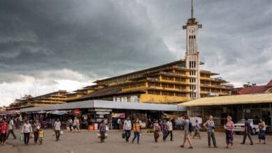 Psar Nat Market's yellow Art Deco building with clock tower in Battambang, Cambodia
