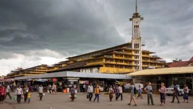 Psar Nat Market's yellow Art Deco building with clock tower in Battambang, Cambodia
