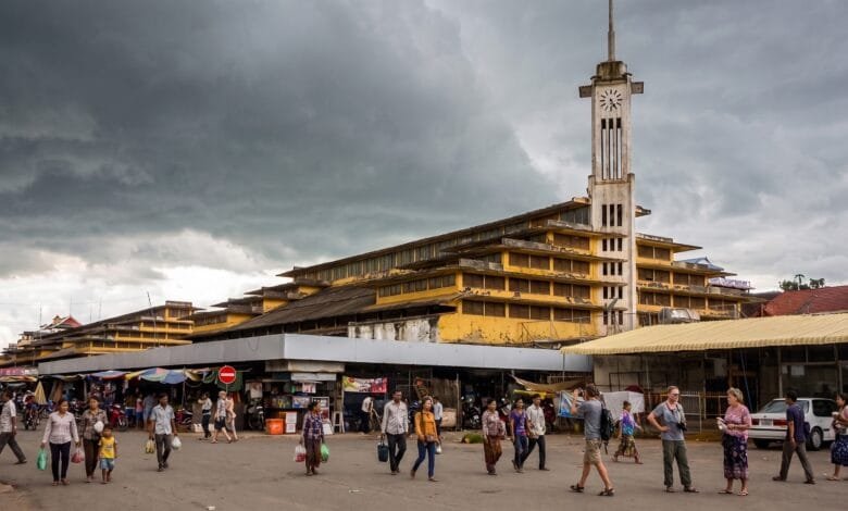 Psar Nat Market's yellow Art Deco building with clock tower in Battambang, Cambodia