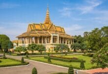Exterior view of the Royal Palace in Phnom Penh, Cambodia, with golden spires and yellow walls