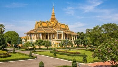 Exterior view of the Royal Palace in Phnom Penh, Cambodia, with golden spires and yellow walls