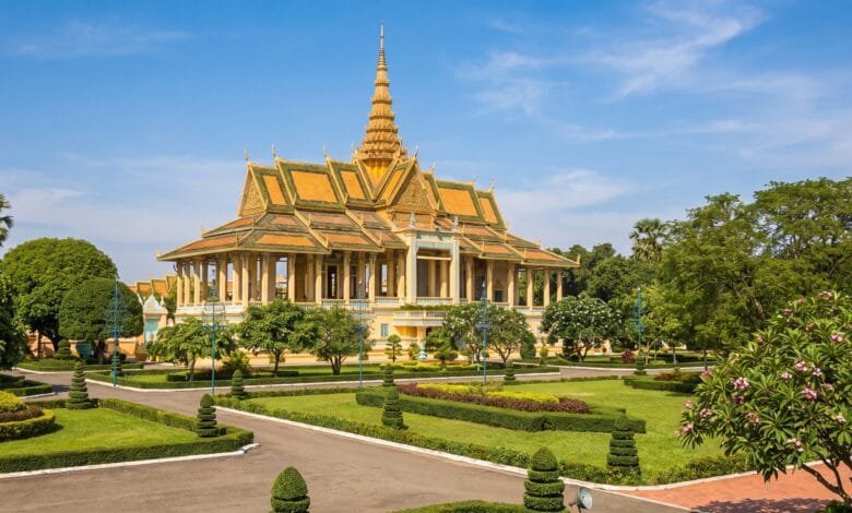 Exterior view of the Royal Palace in Phnom Penh, Cambodia, with golden spires and yellow walls