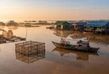 Tonlé Sap floating fish farms with bamboo cages and floating village at sunrise, Cambodia