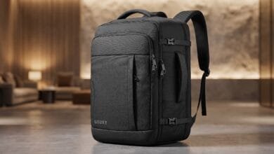 Gieury 50L carry-on travel backpack with expandable capacity and TSA lay-flat laptop compartment, placed on a hotel room floor in Cambodia.