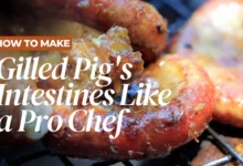 Grilled pig intestines on a plate with chili dipping sauce, a traditional Cambodian recipe