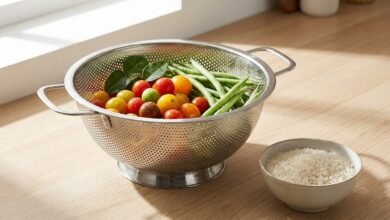 Gulex 3-quart stainless steel colander with footed base on a kitchen counter with vegetables