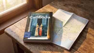 Lonely Planet Cambodia travel guide book on a table with a map of Cambodia