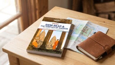 Lonely Planet Pocket Siem Reap & the Temples of Angkor travel guide book on a wooden surface with a map.